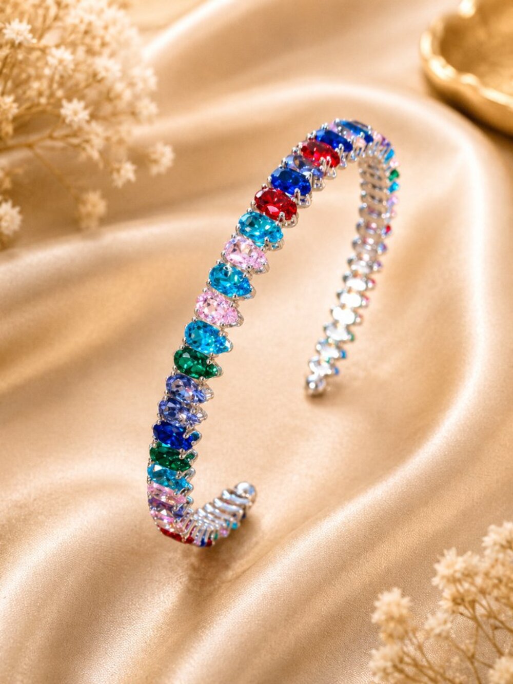Dazzling silver-tone bracelet features a vibrant rainbow colors